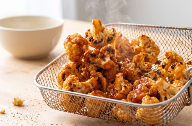 Crispy Air Fryer Buffalo Cauliflower — Coat in buffalo sauce